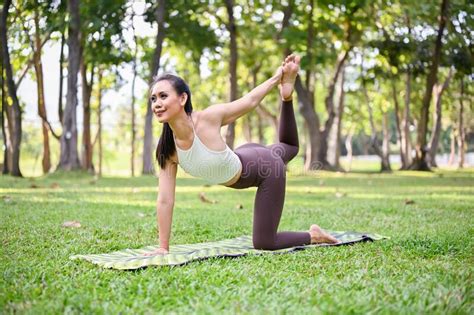 Beautiful Woman Doing Yoga Pose And Stretching Her Body At The Park Stock Image Image Of