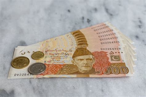 New Banknotes Of Pakistan 5000 Rupees With Coins With Selective Focus