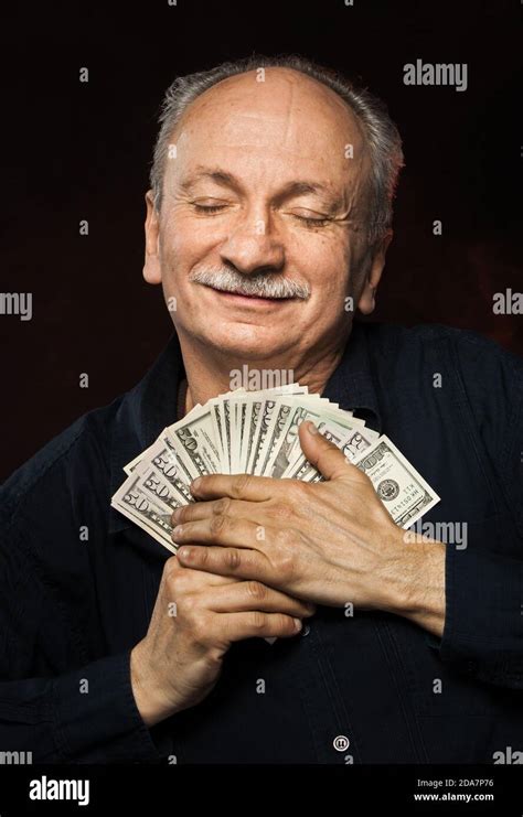 Senior Gentleman Holding A Stack Of Money Portrait Of An Excited Old
