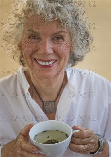 Woman Drinking Herbal Tea Photo Daniel Grill Photo12 Tetra Images