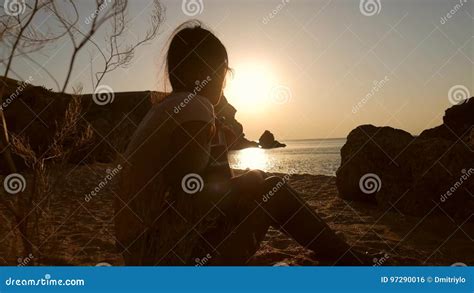 Young Hippie Boho Girl Sitting On Sandy Beach And Playing Ukulele