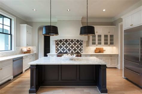 If your kitchen island has cabinets, painting them black is a great way to subtly get in on the trend. Black and White Kitchen with Arteriors Anderson Iron Pendants - Transitional - Kitchen