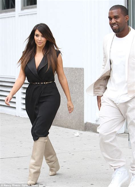 Kim Kardashian Grapples With Her Cleavage Baring Dress As
