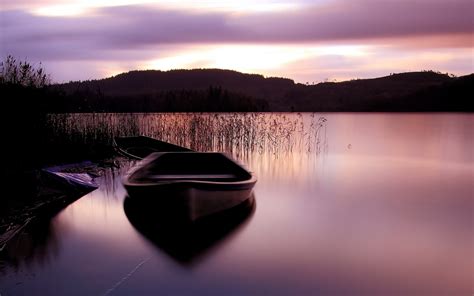 Lake Surface Boat Grass Mountains Sunset Scenery Hd Wallpaper Preview