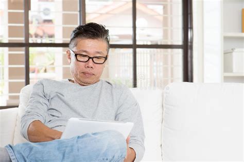 Mature Asian Man Using Tablet Computer Stock Image Image Of Online Reading 63435351