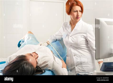 Gynecologist Doing Ultrasound Scanning For Pregnant Woman Stock Photo