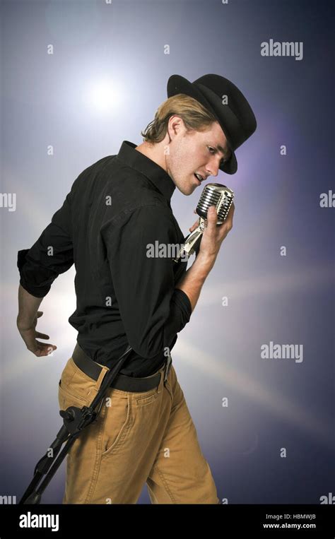 Man Singing Into Microphone Stock Photo Alamy