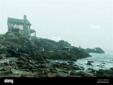 Beach House Overlooking A Foggy Sea Along The Maine Coast Stock Photo