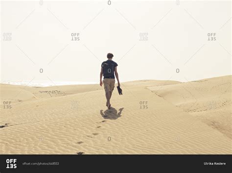 Man Walking Alone In The Desert Stock Photo Offset