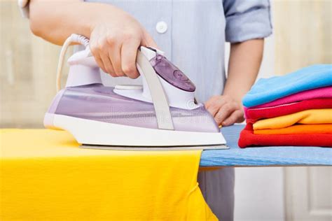 Pile Of Laundry And Iron On Ironing Board Stock Photo Image Of Board