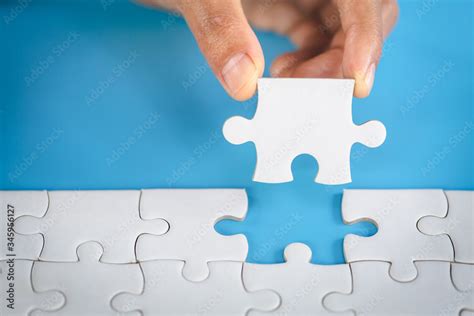 Hand Put The Last Piece Of Jigsaw Puzzle To Complete The Mission