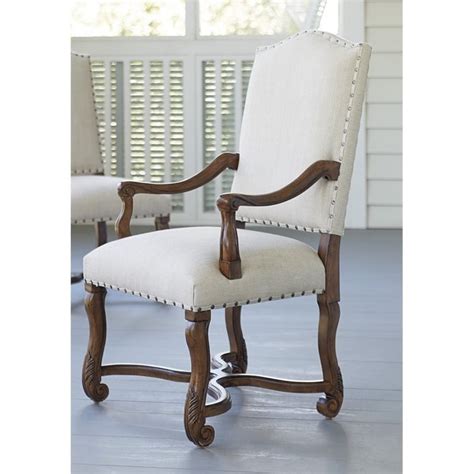 With their comfortable upholstered design, they provide a welcome place to eat and chat with others over food. Paula Deen Home Dogwood Upholstered Dining Arm Chair in ...