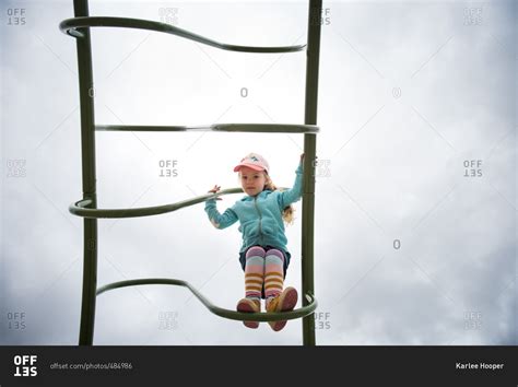 Little Girl Climbing On A Ladder At A Playground Stock Photo Offset