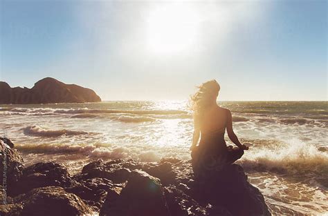 Pretty Woman Meditating By The Ocean By Visualspectrum Stocksy United