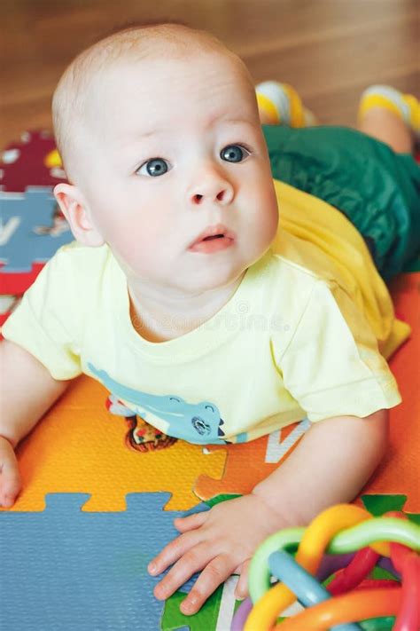 Infant Baby Child Boy Six Months Old Is Playing On A Floor Stock Image