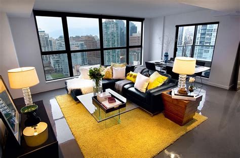 Black Couch Adds Visual Punch To The Living Room In Yellow And Grey