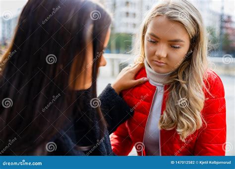 Young Woman Comforting Her Upset And Sad Friend Outdoor Stock Photo