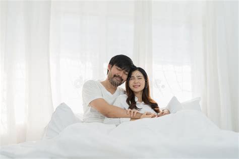 Asian Romantic Couple In Bed Enjoying Sensual Foreplay Happy Sensual Young Couple Lying In Bed