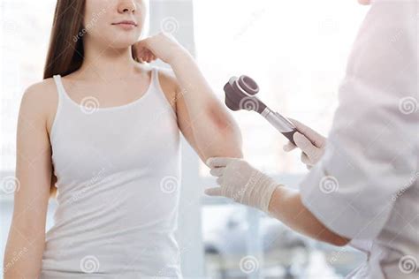 Helpful Dermatologist Using Dermatoscope For Allergy Examination In The