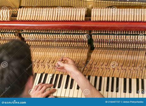 Piano Tuning Process Closeup Of Hand And Tools Of Tuner Working On