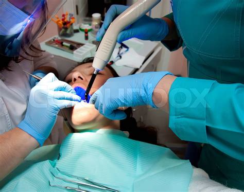 The Dentist Treats Teeth To The Patient Surgical Instruments Stock
