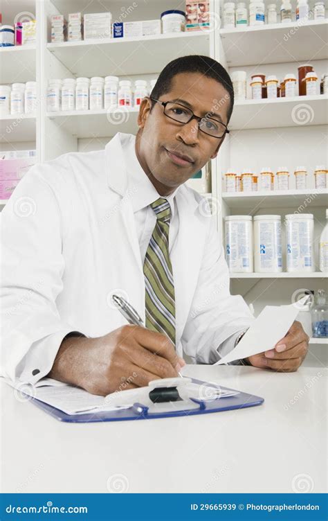 Male Pharmacist Filling Out Medical Documentation Prescription Drugs