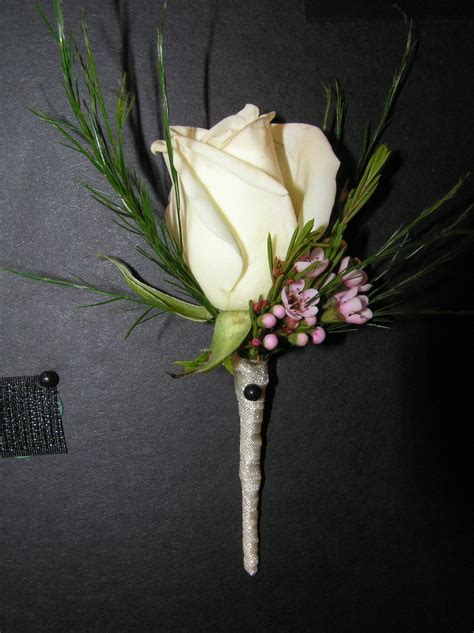 Boutonnniere White Rose With Waxflower And Fern Accents And Silver