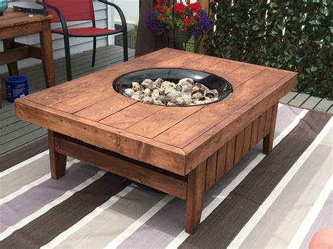 A Wooden Table Sitting On Top Of A Rug Next To A Potted Planter