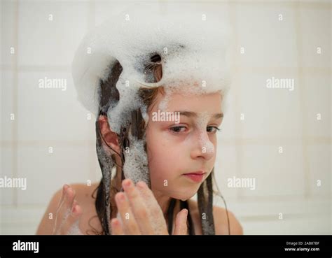 Young Girl Inside The Bath A Little Girl Bathes In A Bathtub With Foam