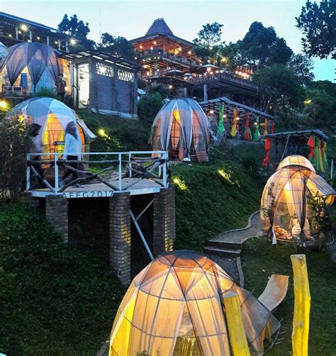 The Domes Are Lit Up At Night In Front Of An Outdoor Area With Stairs