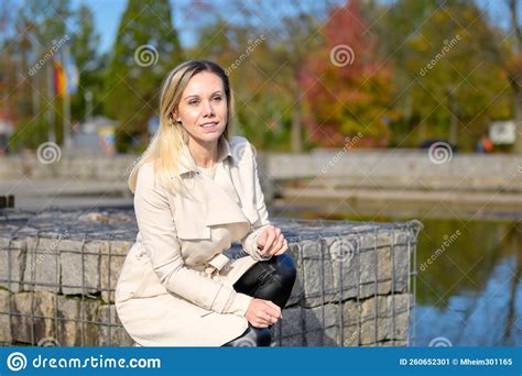 woman kneeling by a lake stock image image of fall 260652301