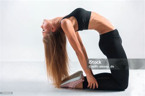 Young Woman Bending Backwards Standing On Her Knees Workout Stock Photo