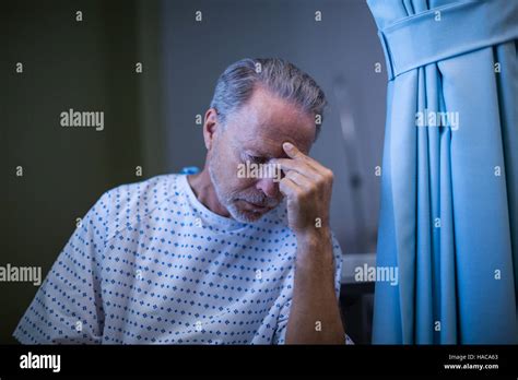 Sad Patient Sitting On Chair With Hand On Head Stock Photo Alamy