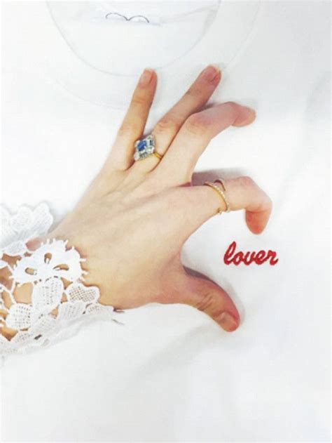 A Womans Hand With A Ring On It And The Word Lover Written In Red