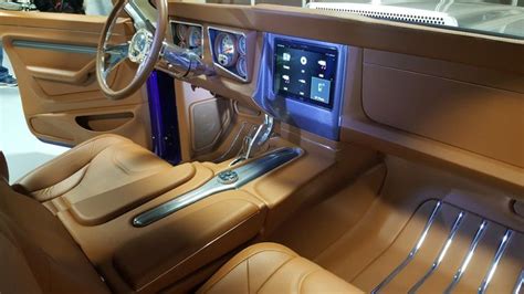 The Interior Of A Luxury Car With Tan Leather Seats And Electronic