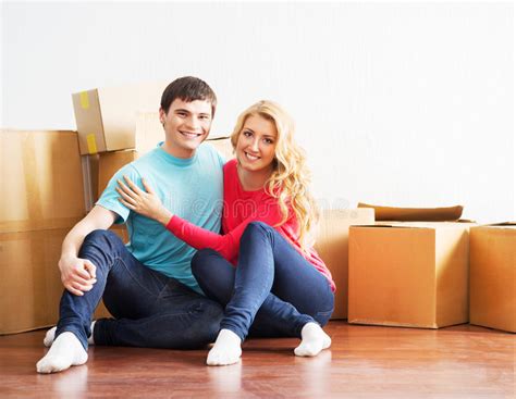 Young Couple Moving Into A New Home Stock Photo Image Of Floor