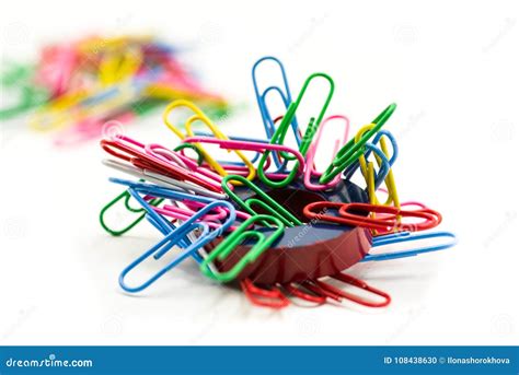 Magnet Covered By Paper Clips On A White Background Stock Photo Image