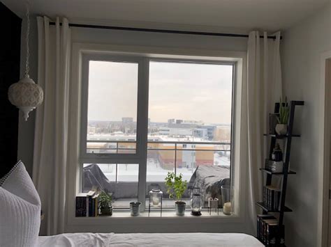 A slanted ceiling adds character to a room but it can make decorating difficult. How to Hang Curtains to Make Your Ceiling Look Taller