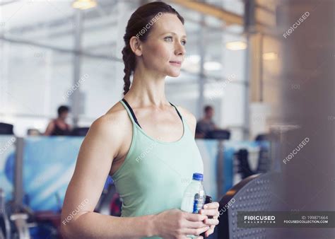 Pensive Woman Drinking Water At Gym — Cool Down Exercising Stock