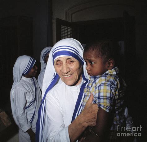 Mother Teresa Holding Young Boy Photograph By Bettmann Pixels