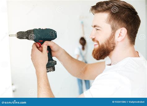Portrait Of Cheerful Man Using Drill To Make Repair Stock Photo Image