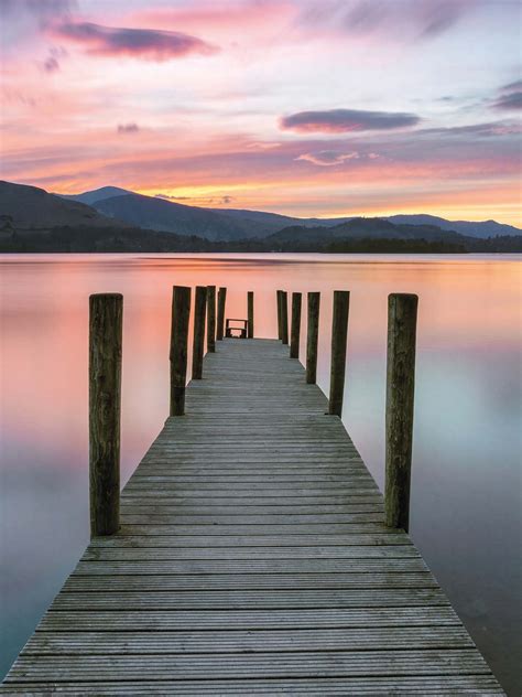 Dock On A Lake At Sunset