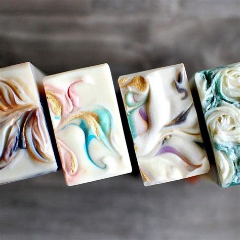 Four Soap Bars With Different Designs On Them