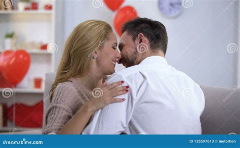 Passionate Husband And Wife Nuzzling And Hugging Spending Holiday