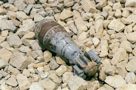 Premium Photo An Unexploded Mortar Mine Lying On The Rocks Clearance