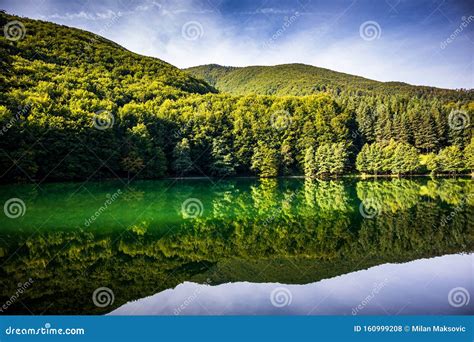 Beautiful Turquoise Lake Surrounded By Green Forest And Mountains Stock