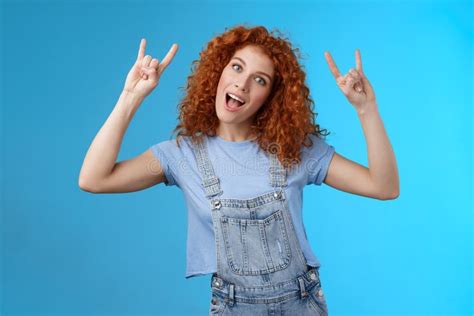 daring cool stylish awesome redhead cheerful curly haired girl tilt head show tongue joyfully