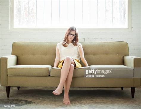 Young Woman Relaxing On Sofa Barefoot Photos And Premium High Res Pictures Getty Images
