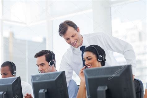 Manager Listening To Call Centre Employee — Stock Photo