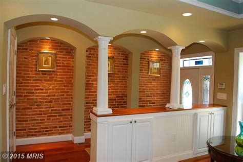 Traditional Hallway With Interior Brick And Columns In